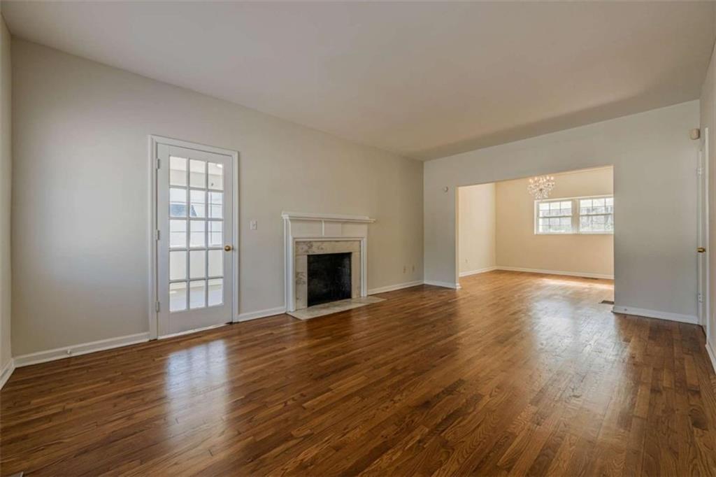 1977 North Decatur Road Atlanta, GA 30307 - Photo 8 of 59 an empty room with wooden floor fireplace and windows