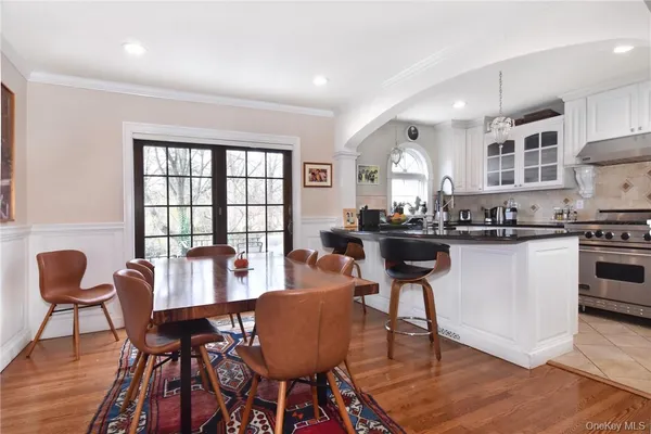 a dining room with furniture and wooden floor