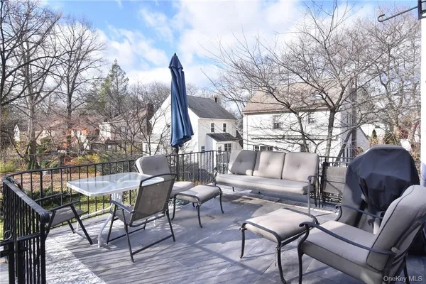 a view of a chairs and tables in the back yard of the house