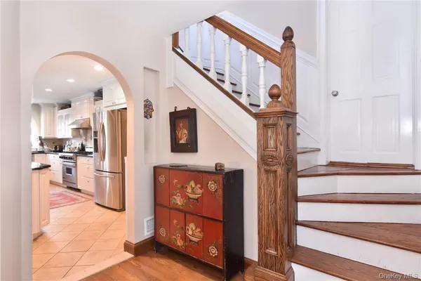 a view of entryway and hall with wooden floor