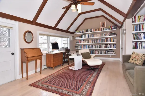 a living room with furniture a rug and white walls
