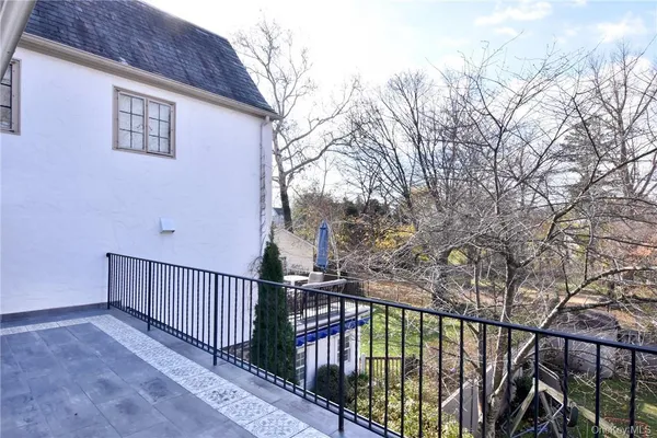 a view of a balcony with wooden floor and fence