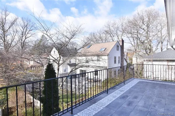 a view of a balcony with wooden fence and floor