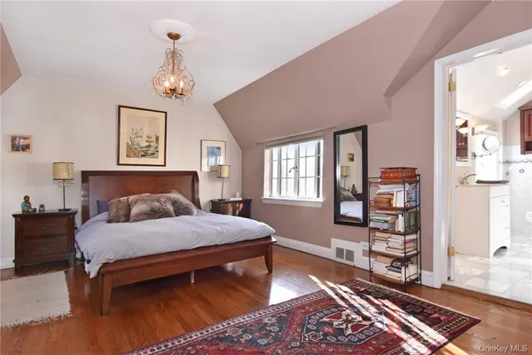a bedroom with a bed dresser and a window