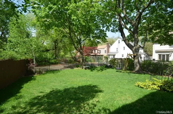 a view of a house with a yard and sitting area