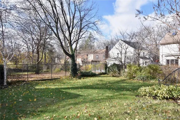 a view of a backyard with large trees
