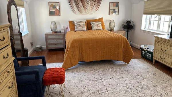 a bedroom with a bed and a tv on the dresser