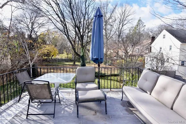 a view of a patio with couches chairs and a fire pit