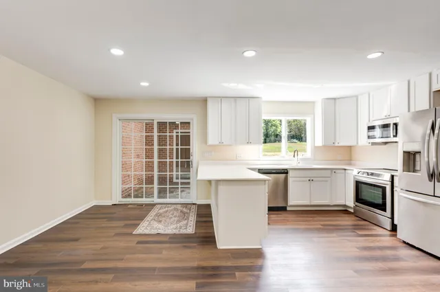 a view of an empty room with white walls