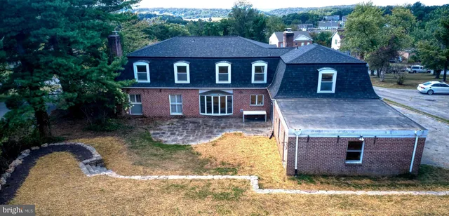 a living room with furniture a fireplace and a table