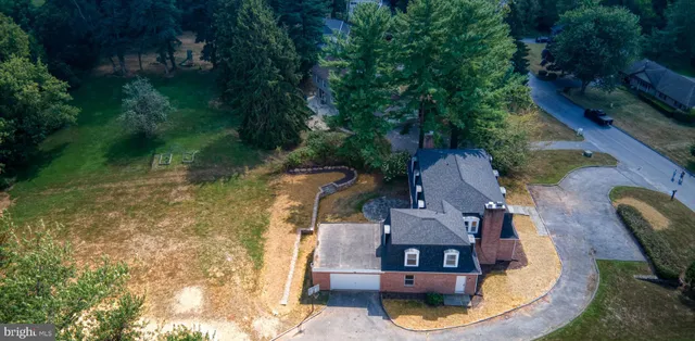 a view of a hallway with wooden floor and entryway