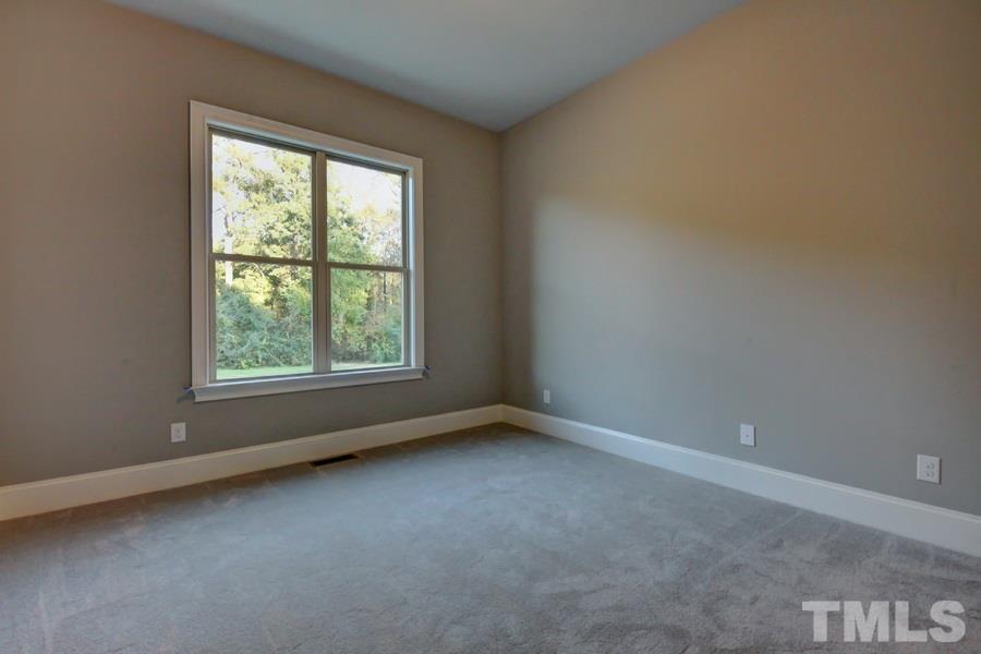 6909 Old Mills Road Fuquay-Varina, NC 27526 - Photo 12 of 25 an empty room with a window