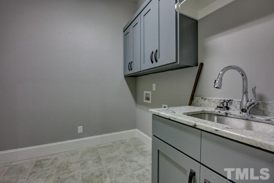 6909 Old Mills Road Fuquay-Varina, NC 27526 - Photo 14 of 25 a bathroom with a sink and a mirror