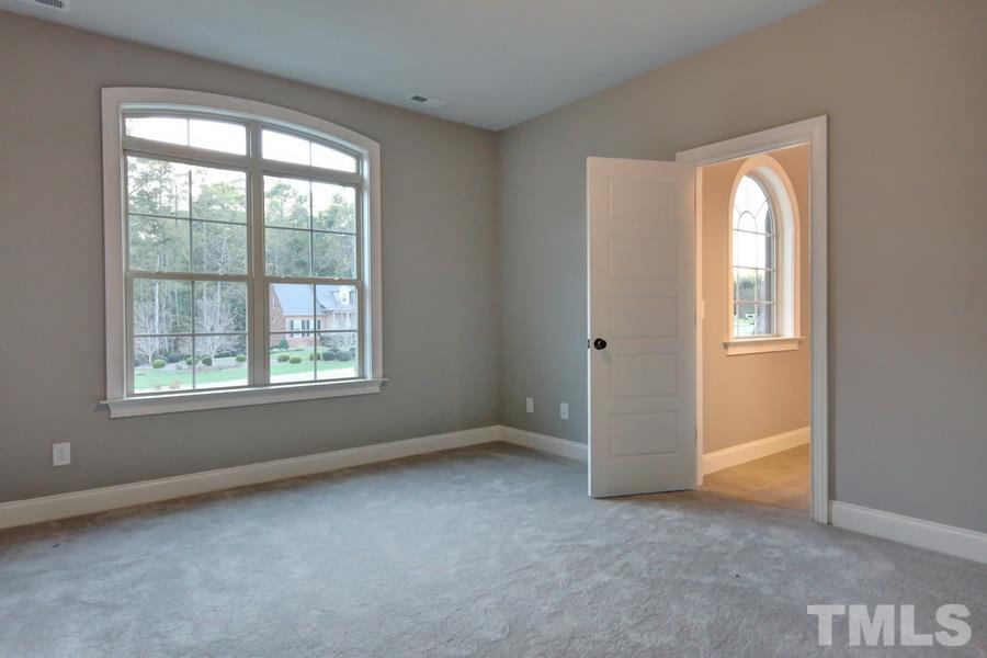 6909 Old Mills Road Fuquay-Varina, NC 27526 - Photo 15 of 25 an empty room with windows