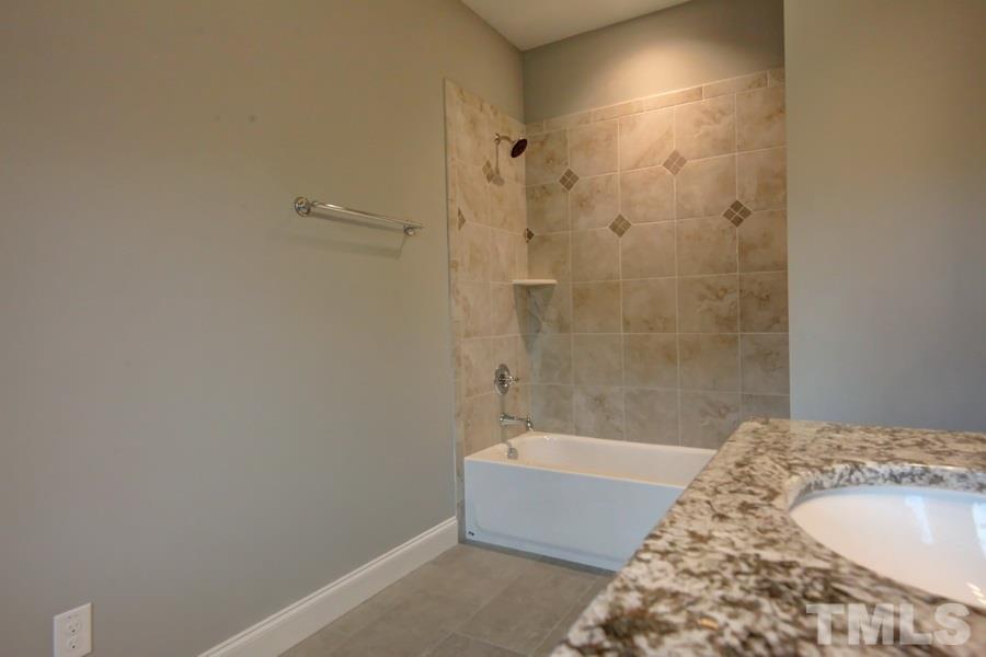 6909 Old Mills Road Fuquay-Varina, NC 27526 - Photo 16 of 25 a bathroom with a bathtub and shower