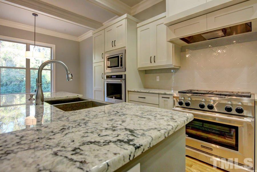 6909 Old Mills Road Fuquay-Varina, NC 27526 - Photo 3 of 25 a kitchen with a stove and a refrigerator