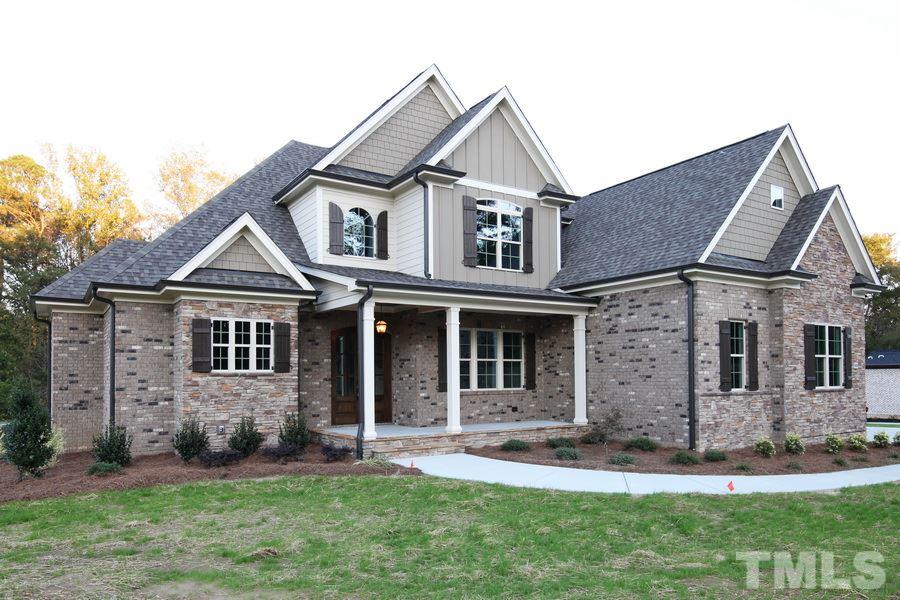 6909 Old Mills Road Fuquay-Varina, NC 27526 - Photo 21 of 25 a front view of a house with a yard