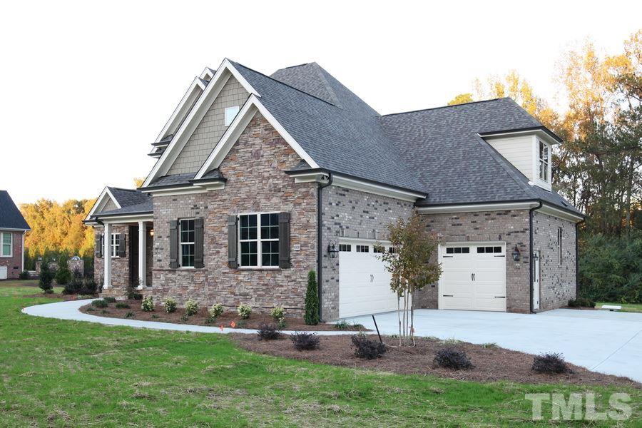 6909 Old Mills Road Fuquay-Varina, NC 27526 - Photo 24 of 25 a front view of a house with a yard