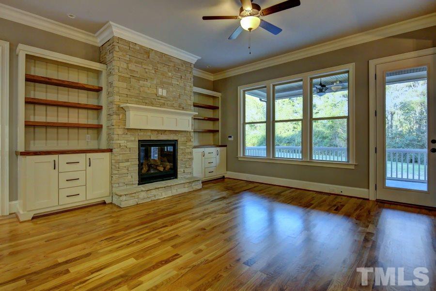 6909 Old Mills Road Fuquay-Varina, NC 27526 - Photo 4 of 25 a view of an empty room with wooden floor and a window