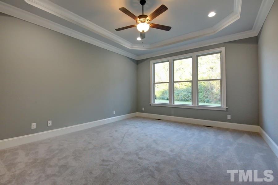 6909 Old Mills Road Fuquay-Varina, NC 27526 - Photo 8 of 25 an empty room with a window and a ceiling fan