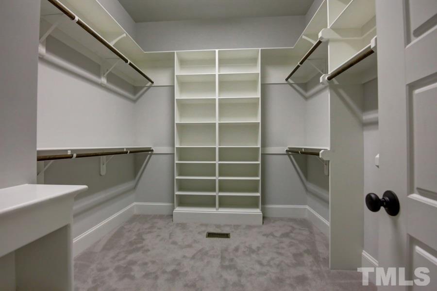 6909 Old Mills Road Fuquay-Varina, NC 27526 - Photo 9 of 25 a view of walk in closet with empty racks