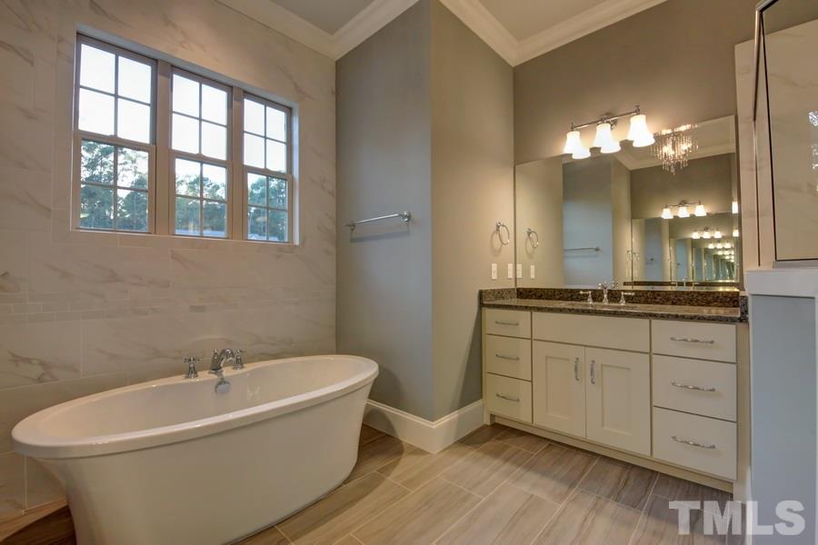 6909 Old Mills Road Fuquay-Varina, NC 27526 - Photo 10 of 25 a white bath tub sitting next to a white sink