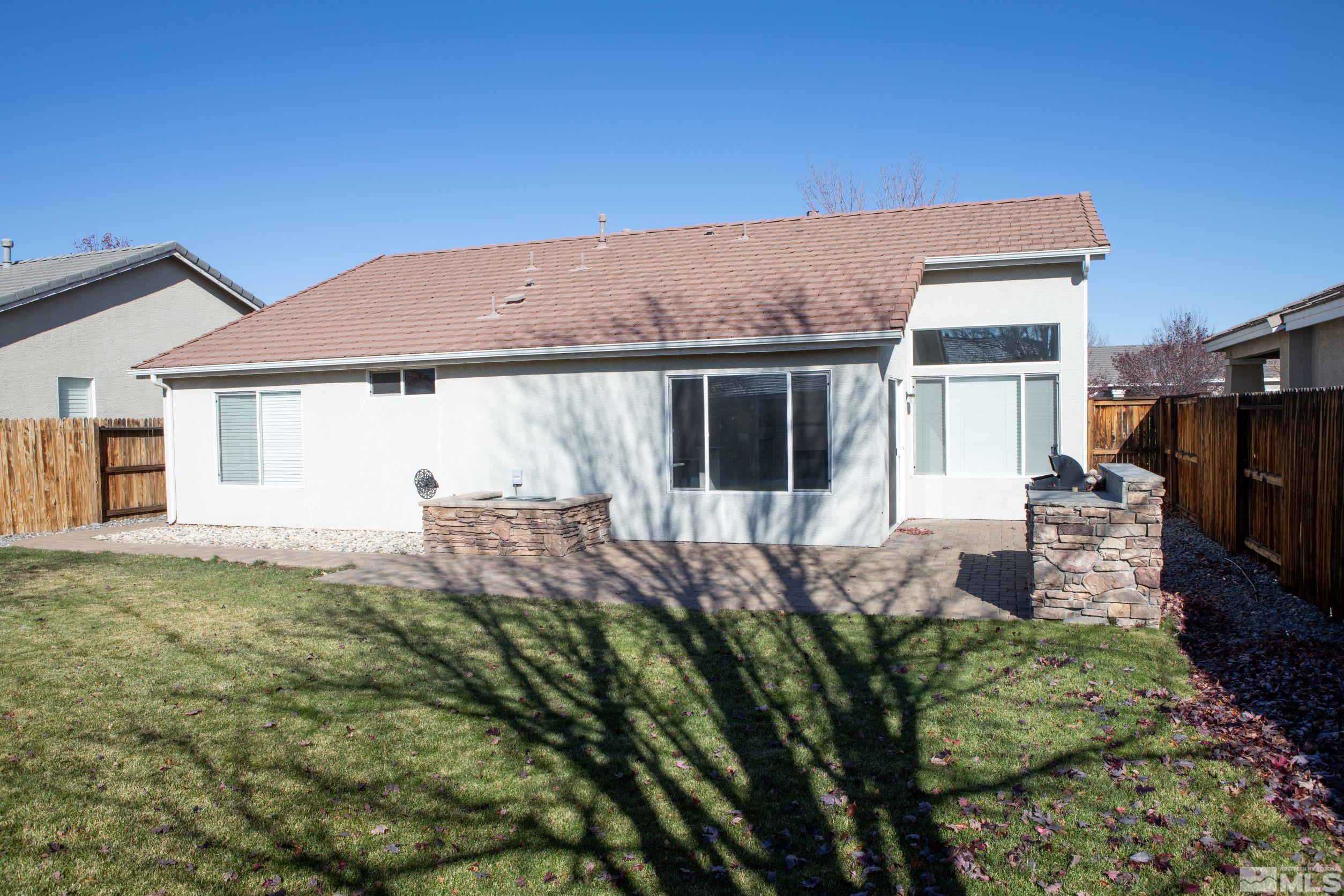 1754 River Gorge Drive Reno, NV 89521 - Photo 18 of 18 a backyard of a house with table and chairs