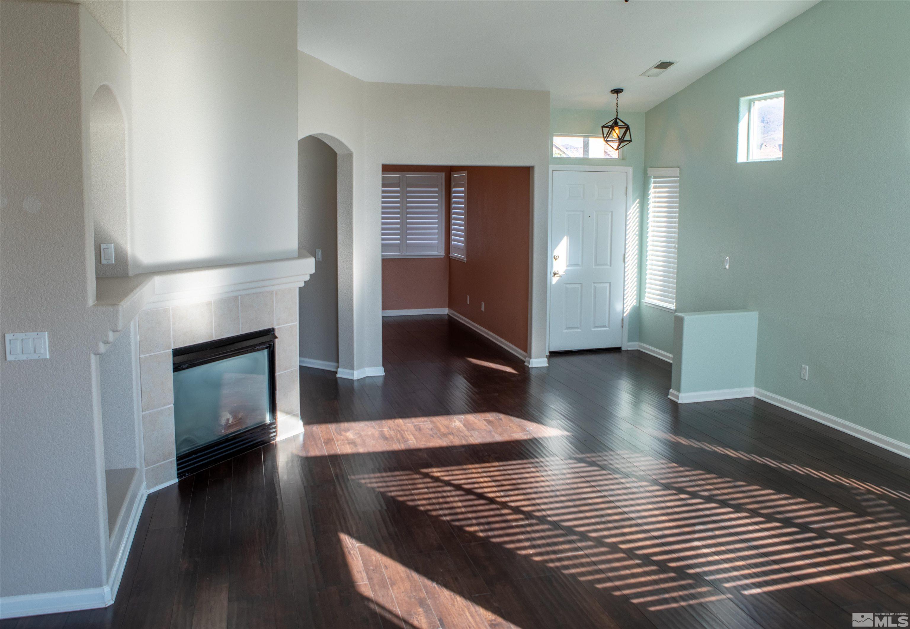 1754 River Gorge Drive Reno, NV 89521 - Photo 4 of 18 a view of a livingroom with wooden floor and a fireplace