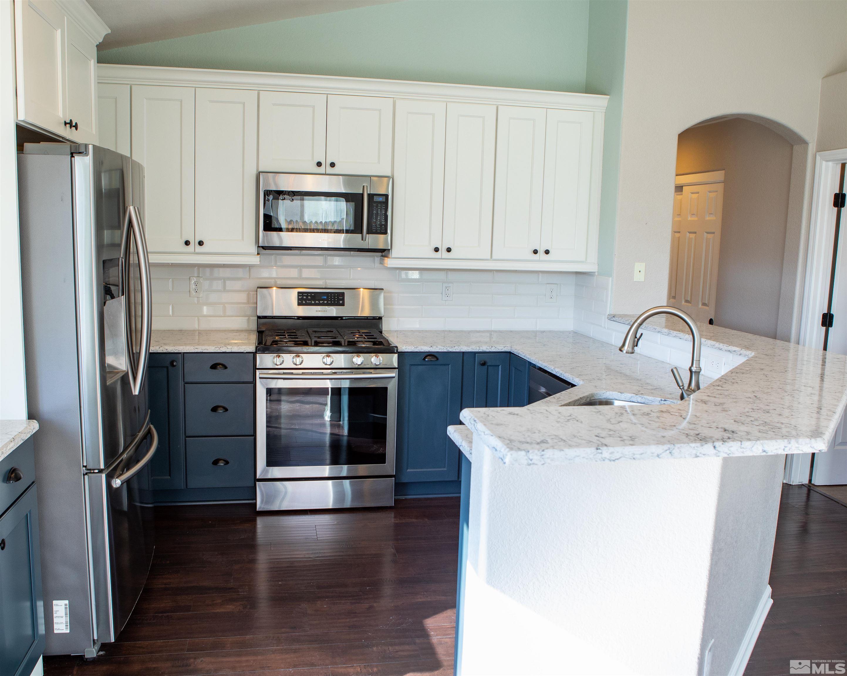 1754 River Gorge Drive Reno, NV 89521 - Photo 6 of 18 a kitchen with granite countertop a sink stove and refrigerator