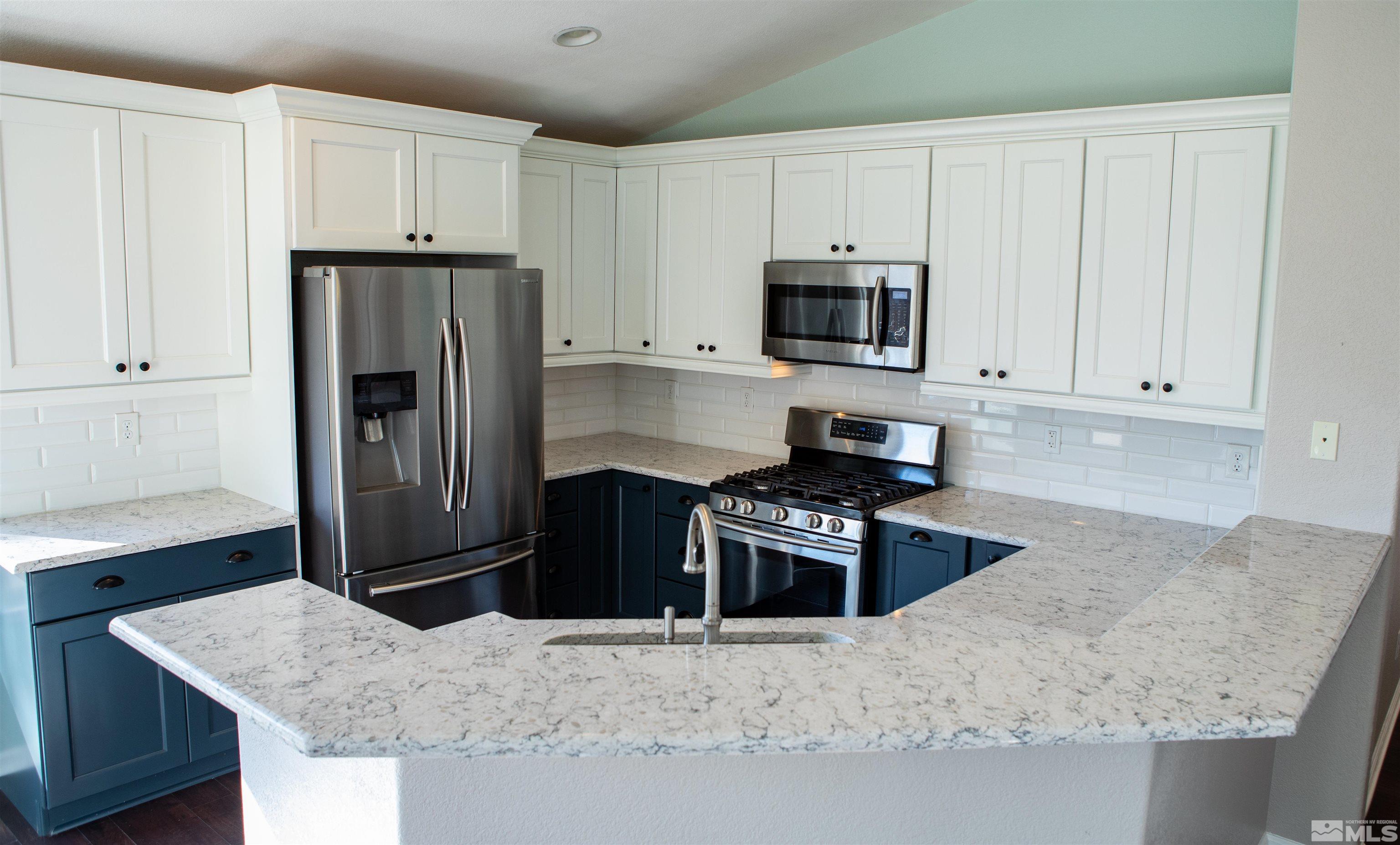 1754 River Gorge Drive Reno, NV 89521 - Photo 7 of 18 a kitchen with granite countertop a refrigerator stove and sink