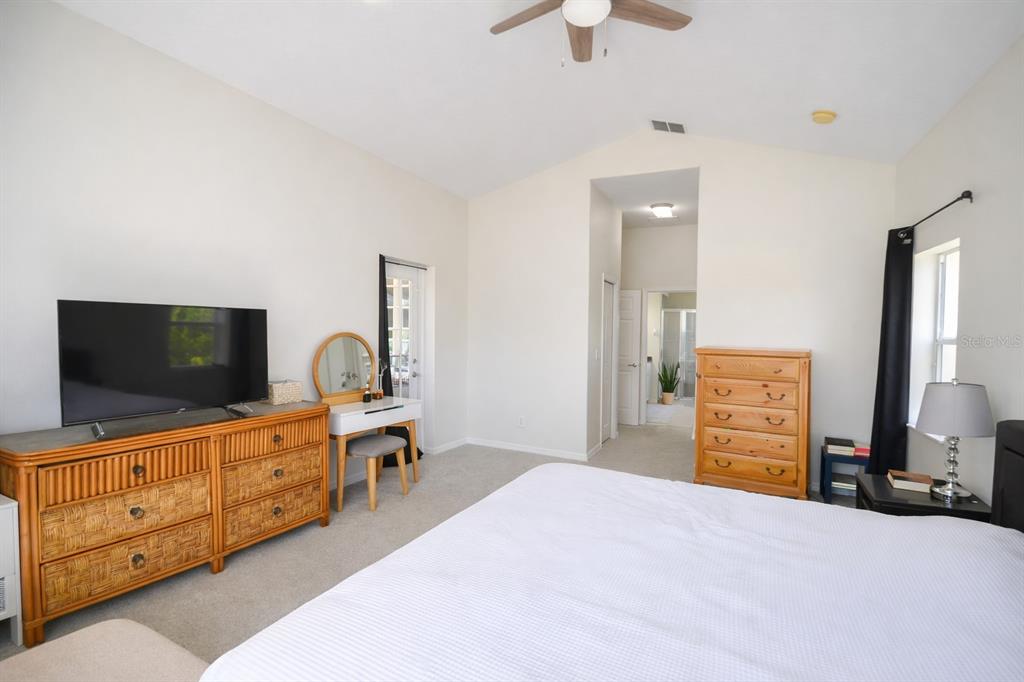 2009 Meadow Rue Court Trinity, FL 34655 - Photo 6 of 21 a bedroom with a bed and a flat screen tv