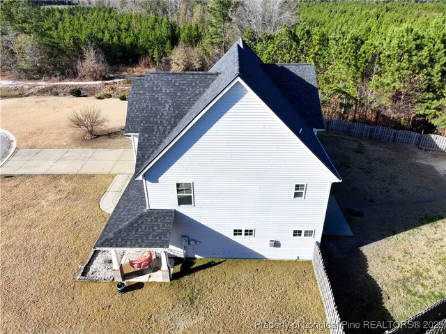 an aerial view of a house with a yard