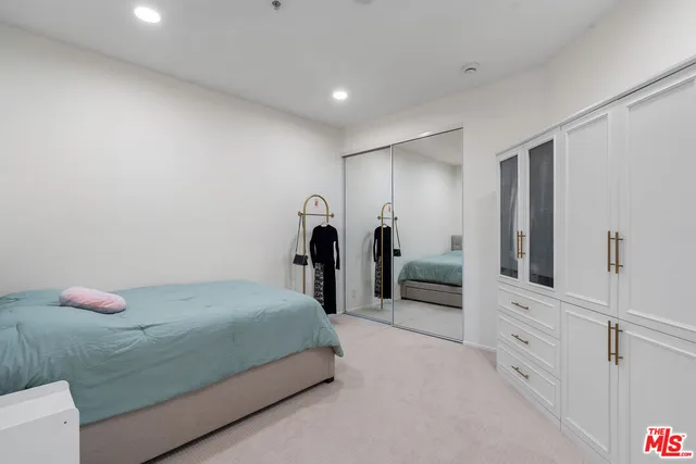 a bedroom with a bed and cabinets