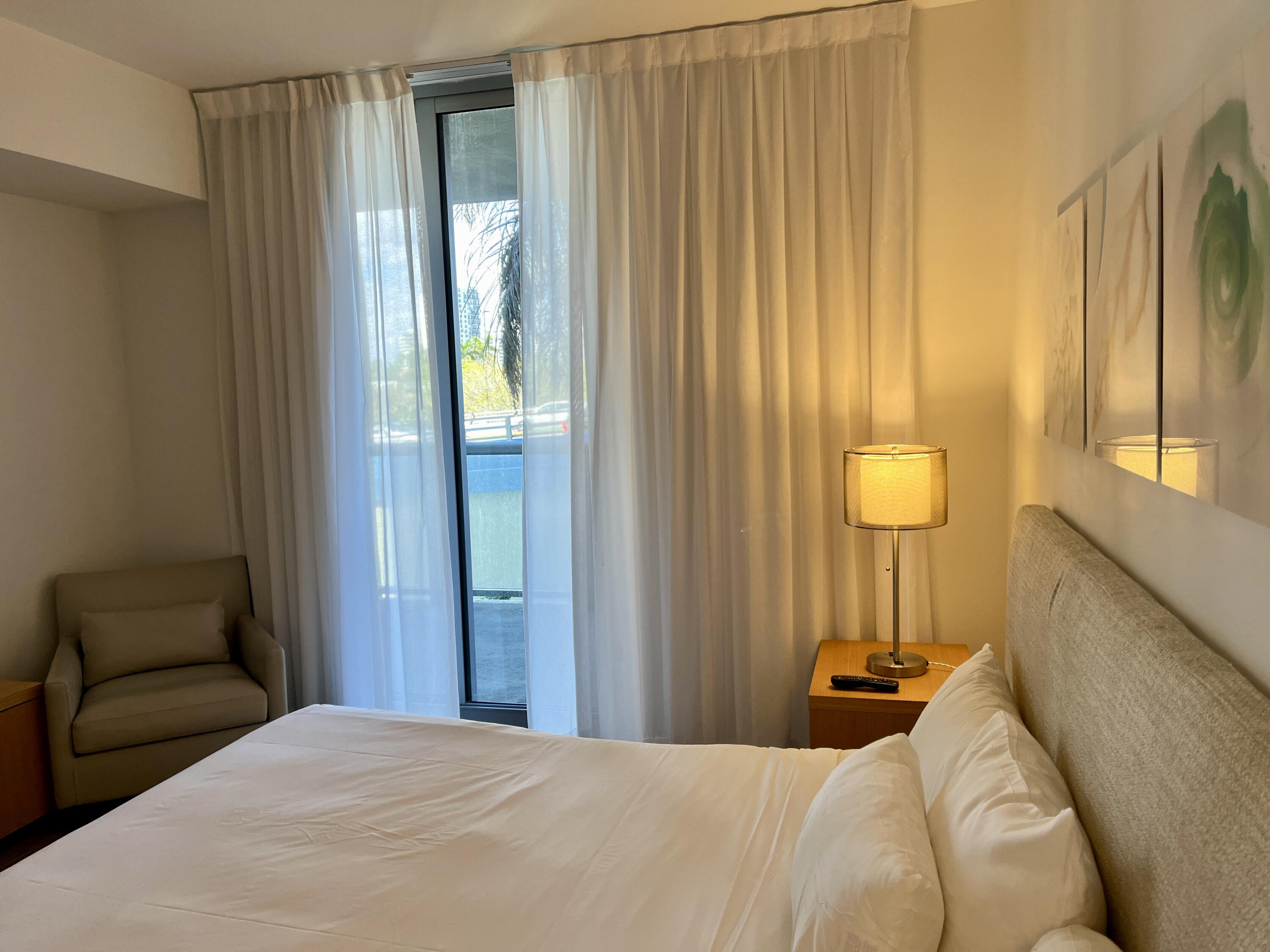 2602 East Hallandale Beach Boulevard, Unit R308 Hallandale Beach, FL 33009 - Photo 13 of 74 a bedroom with a bed and a window