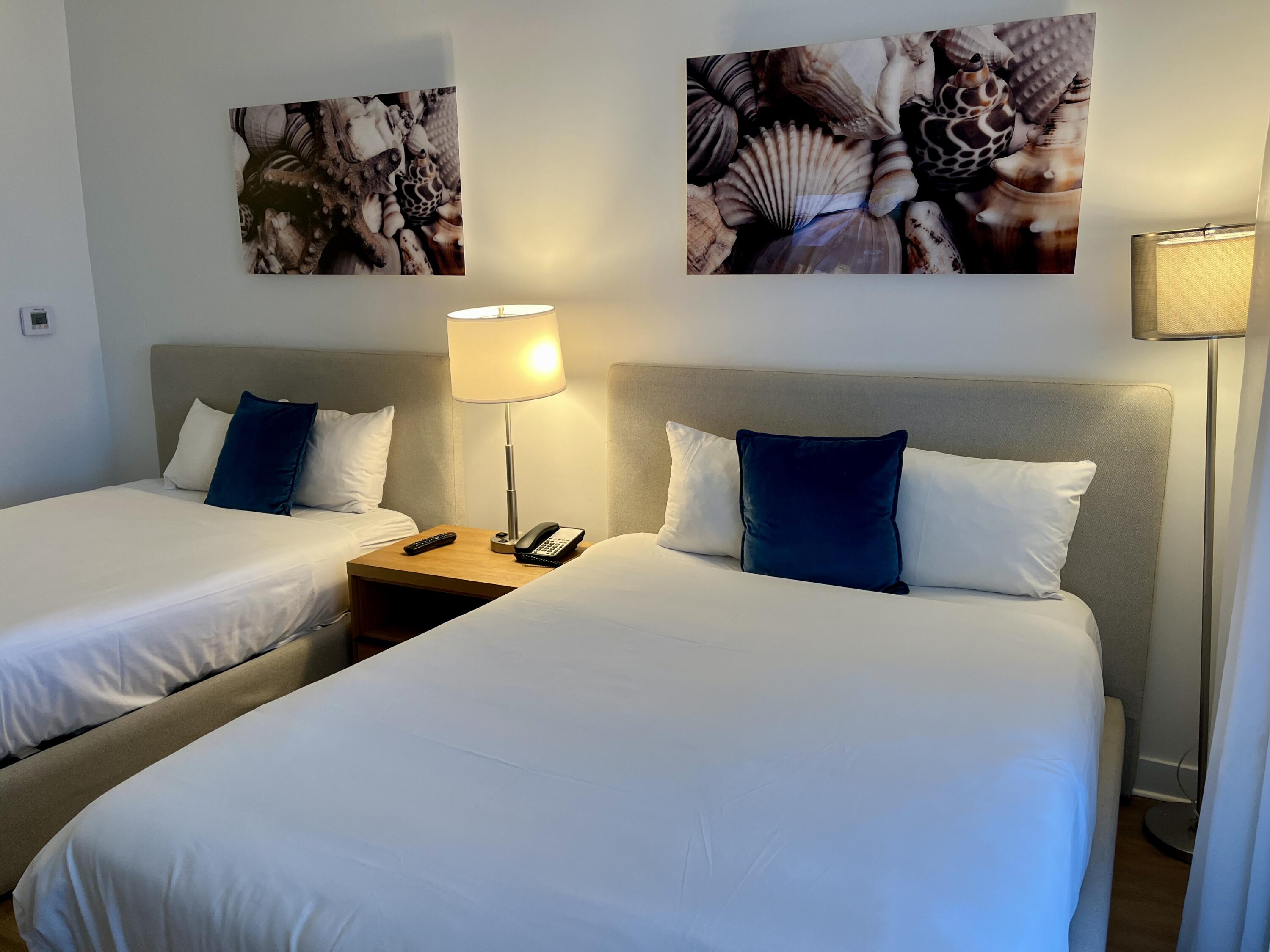 2602 East Hallandale Beach Boulevard, Unit R308 Hallandale Beach, FL 33009 - Photo 25 of 74 a bedroom with two beds and painting on the wall