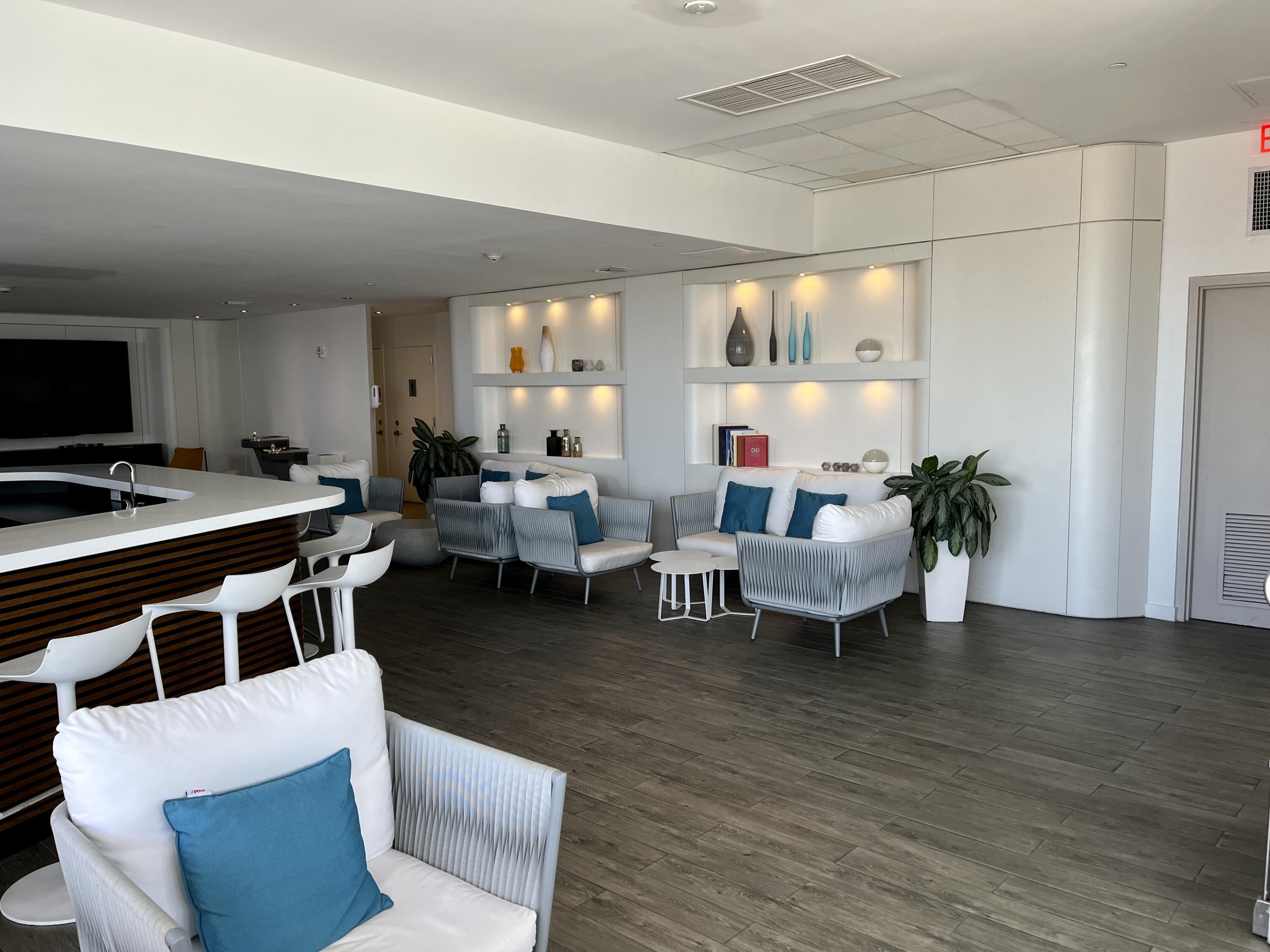 2602 East Hallandale Beach Boulevard, Unit R308 Hallandale Beach, FL 33009 - Photo 39 of 74 a living room with furniture wooden floor and a table
