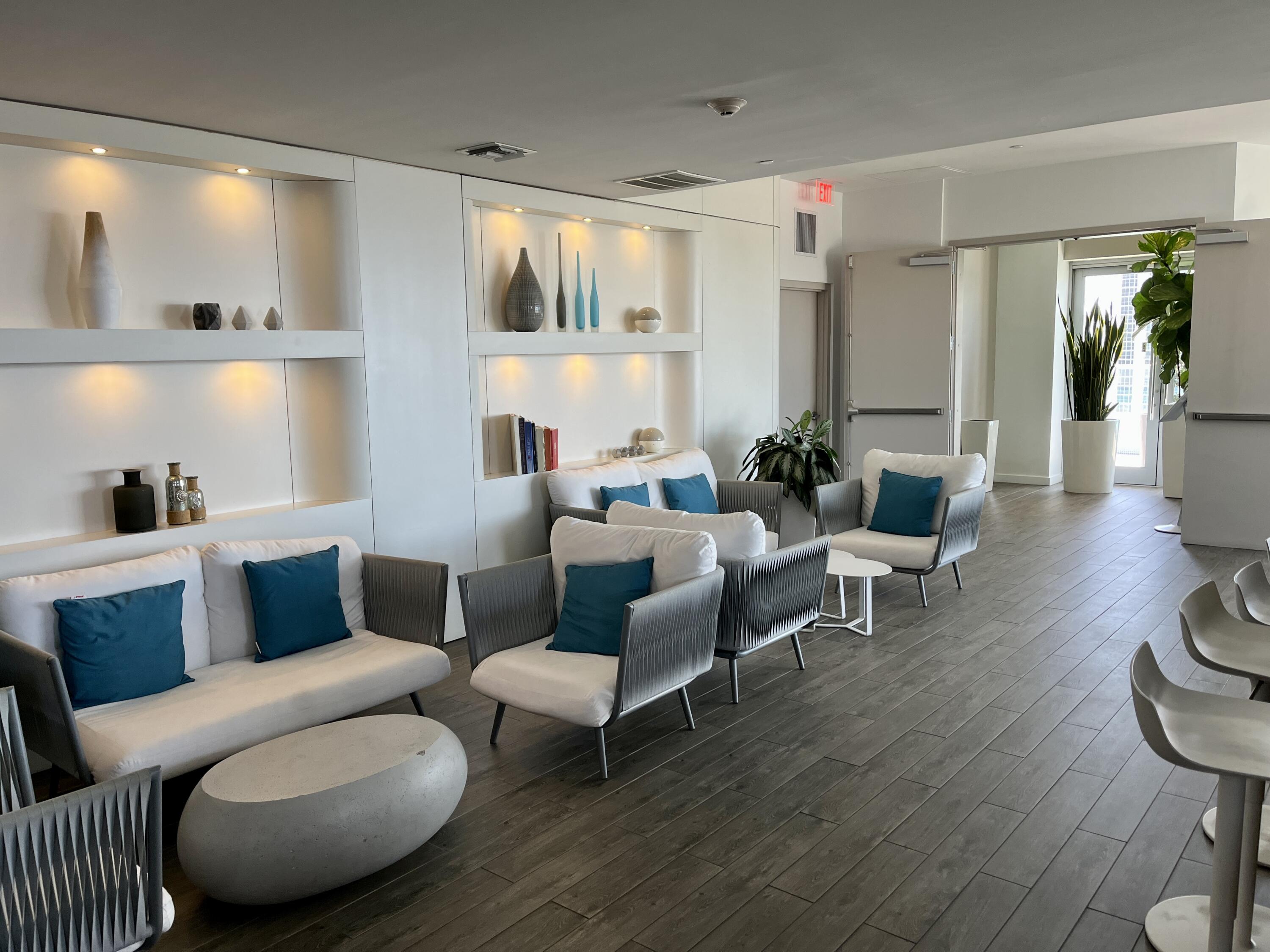 2602 East Hallandale Beach Boulevard, Unit R308 Hallandale Beach, FL 33009 - Photo 42 of 74 a living room with furniture wooden floor and a large window