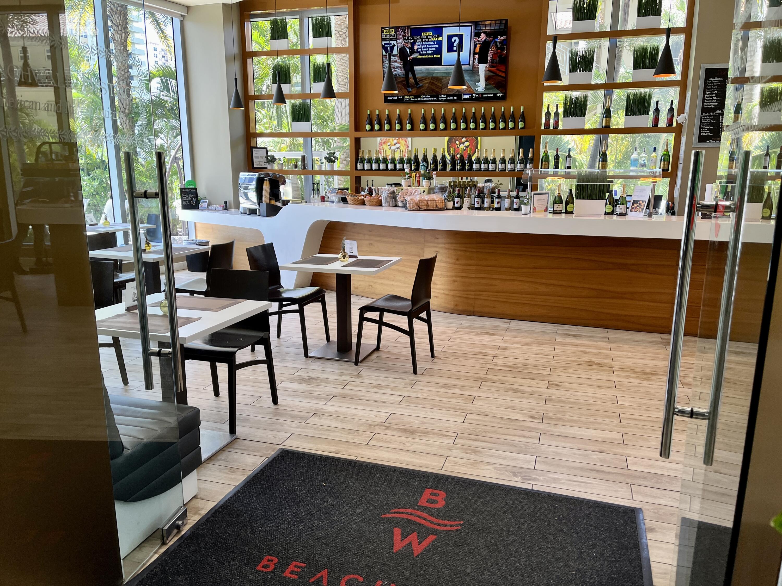2602 East Hallandale Beach Boulevard, Unit R308 Hallandale Beach, FL 33009 - Photo 58 of 74 a dining room with furniture and a floor to ceiling window