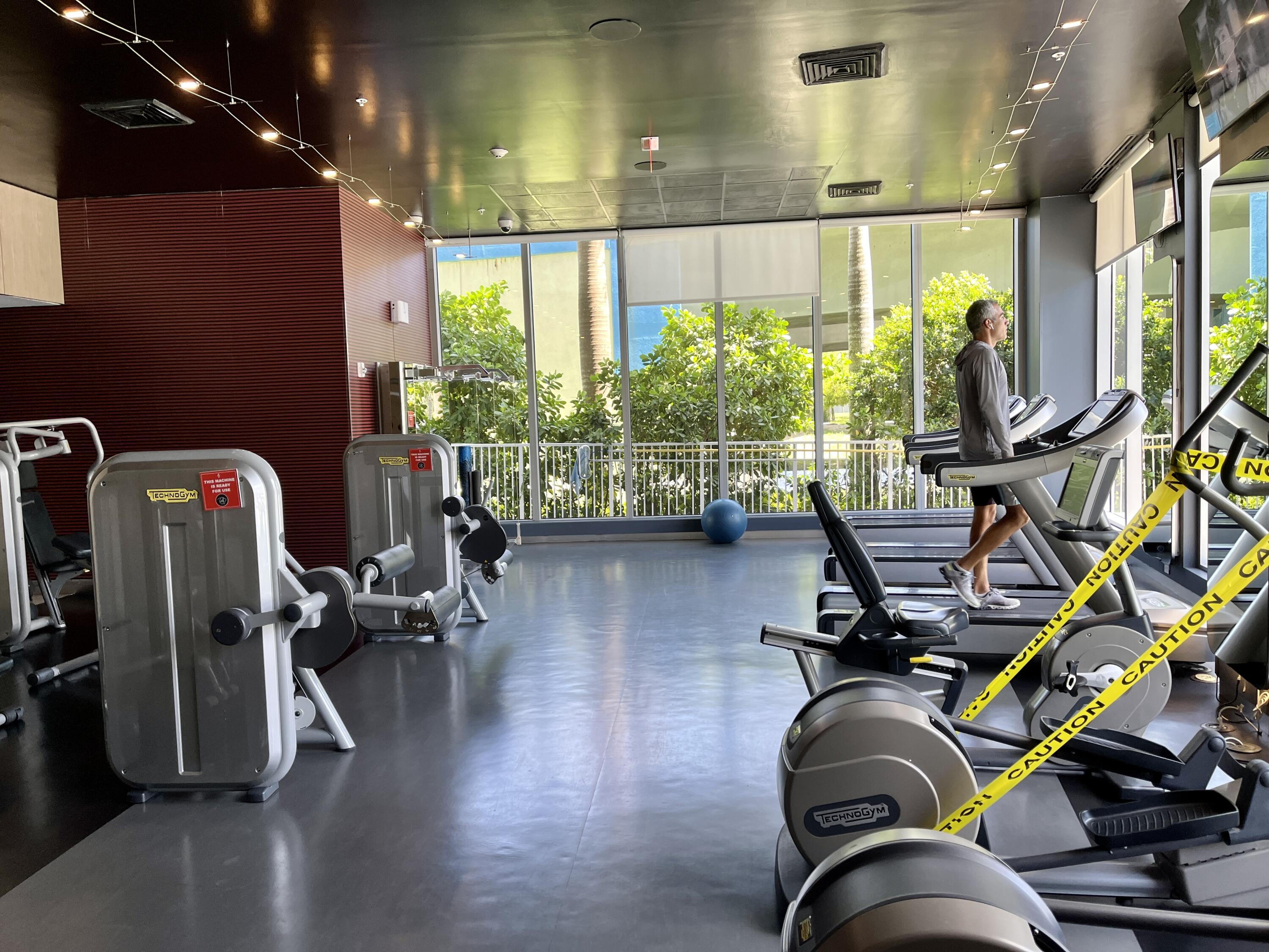 2602 East Hallandale Beach Boulevard, Unit R308 Hallandale Beach, FL 33009 - Photo 62 of 74 a room with gym equipment and windows