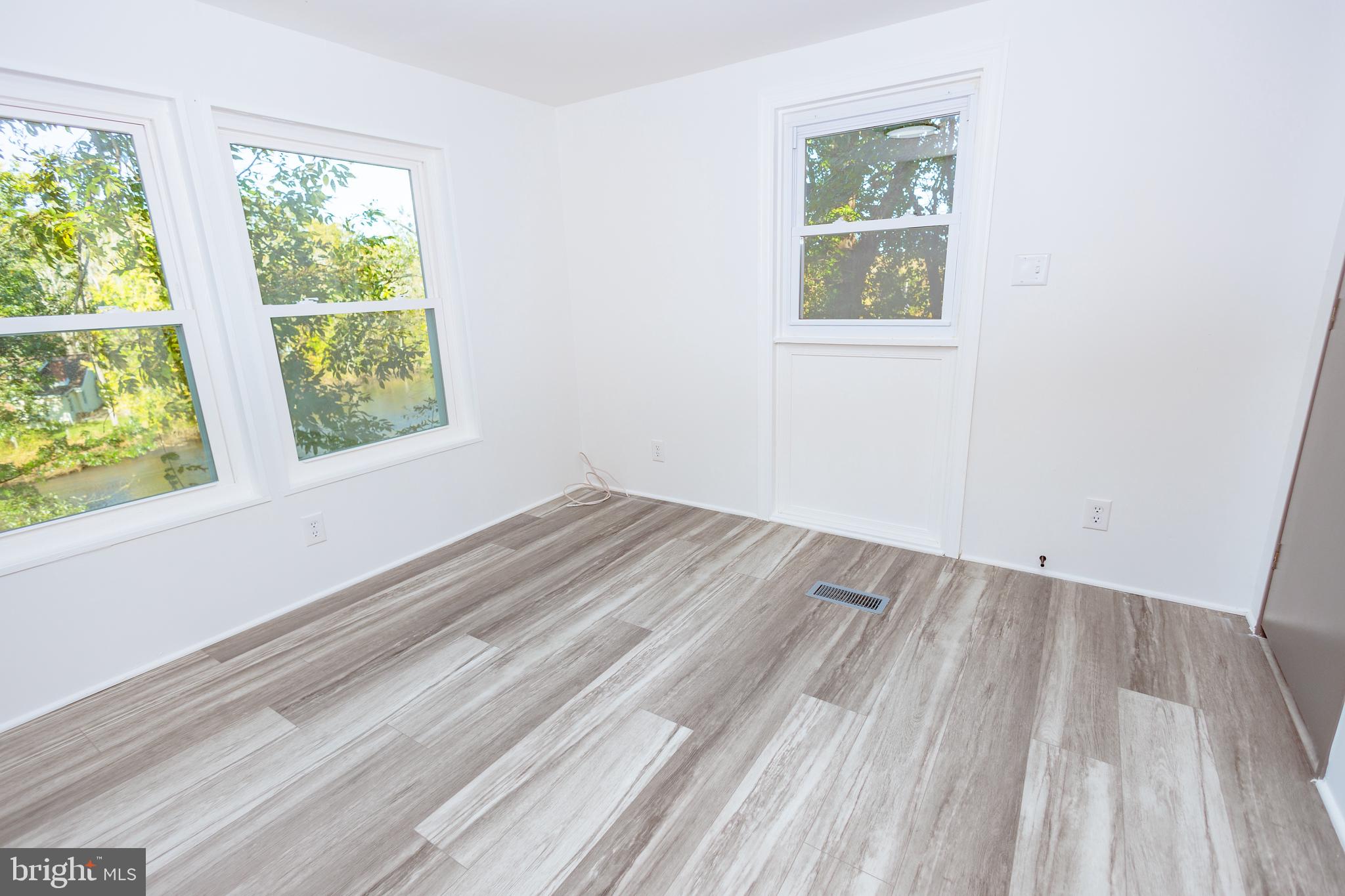85 Hickory Avenue Mantua, NJ 08051 - Photo 12 of 28 wooden floor in an empty room with a window