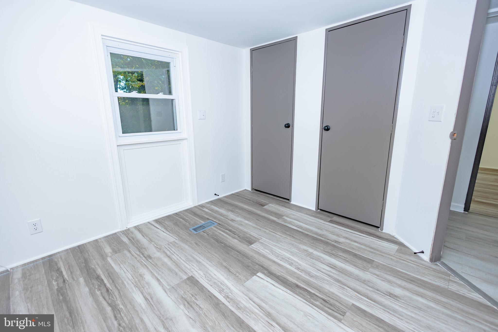 85 Hickory Avenue Mantua, NJ 08051 - Photo 13 of 28 a view of an empty room with wooden floor and a window
