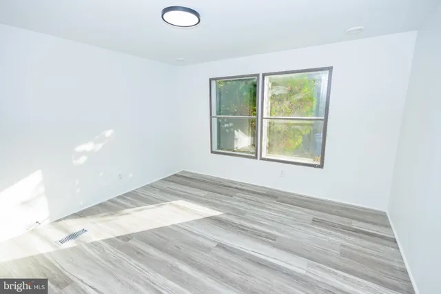a view of a room with wooden floor and bathroom