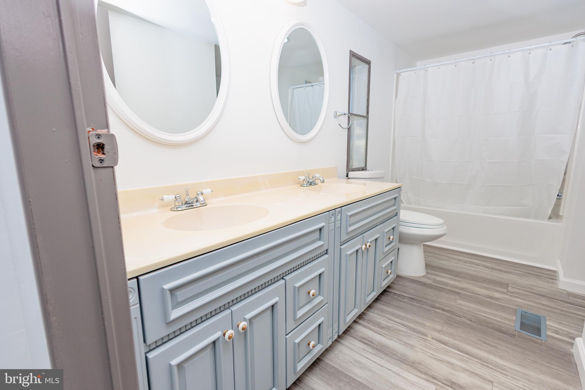 85 Hickory Avenue Mantua, NJ 08051 - Photo 10 of 28 a bathroom with a double vanity sink and a mirror