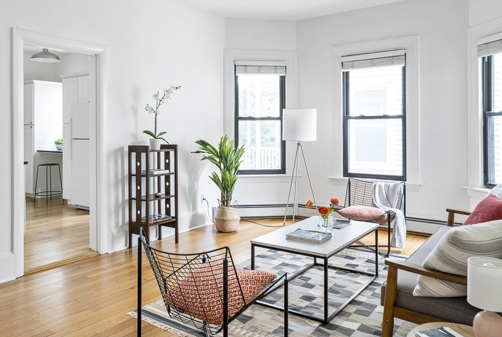 a dining room with furniture wooden floor and a rug