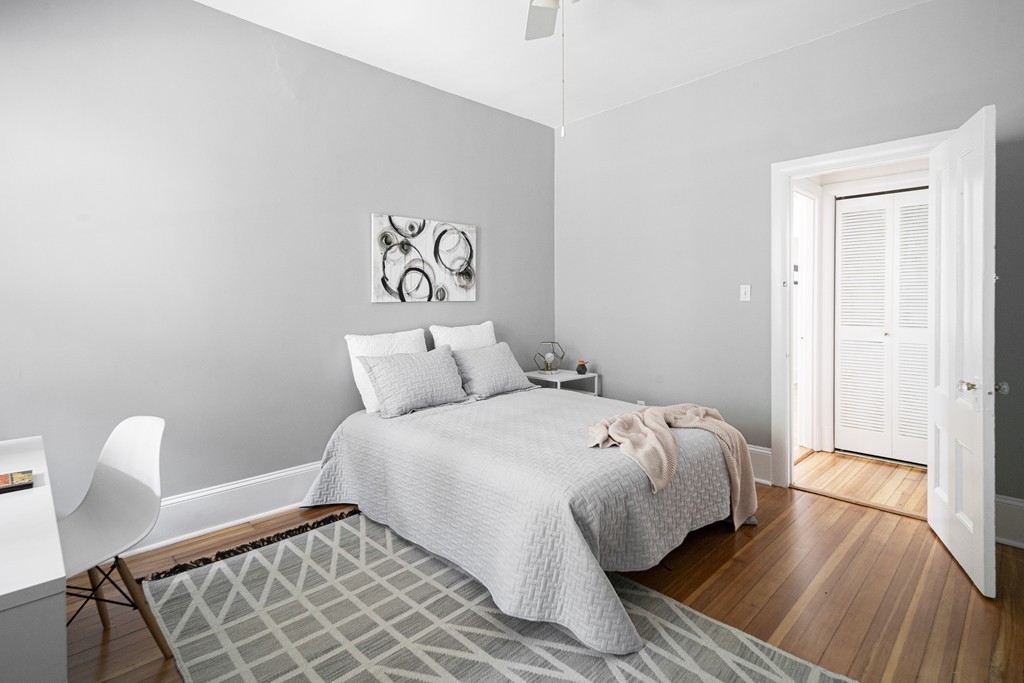 15 Trowbridge Street, Unit 3 Cambridge, MA 02138 - Photo 8 of 14 a bedroom with a bed and a table in it