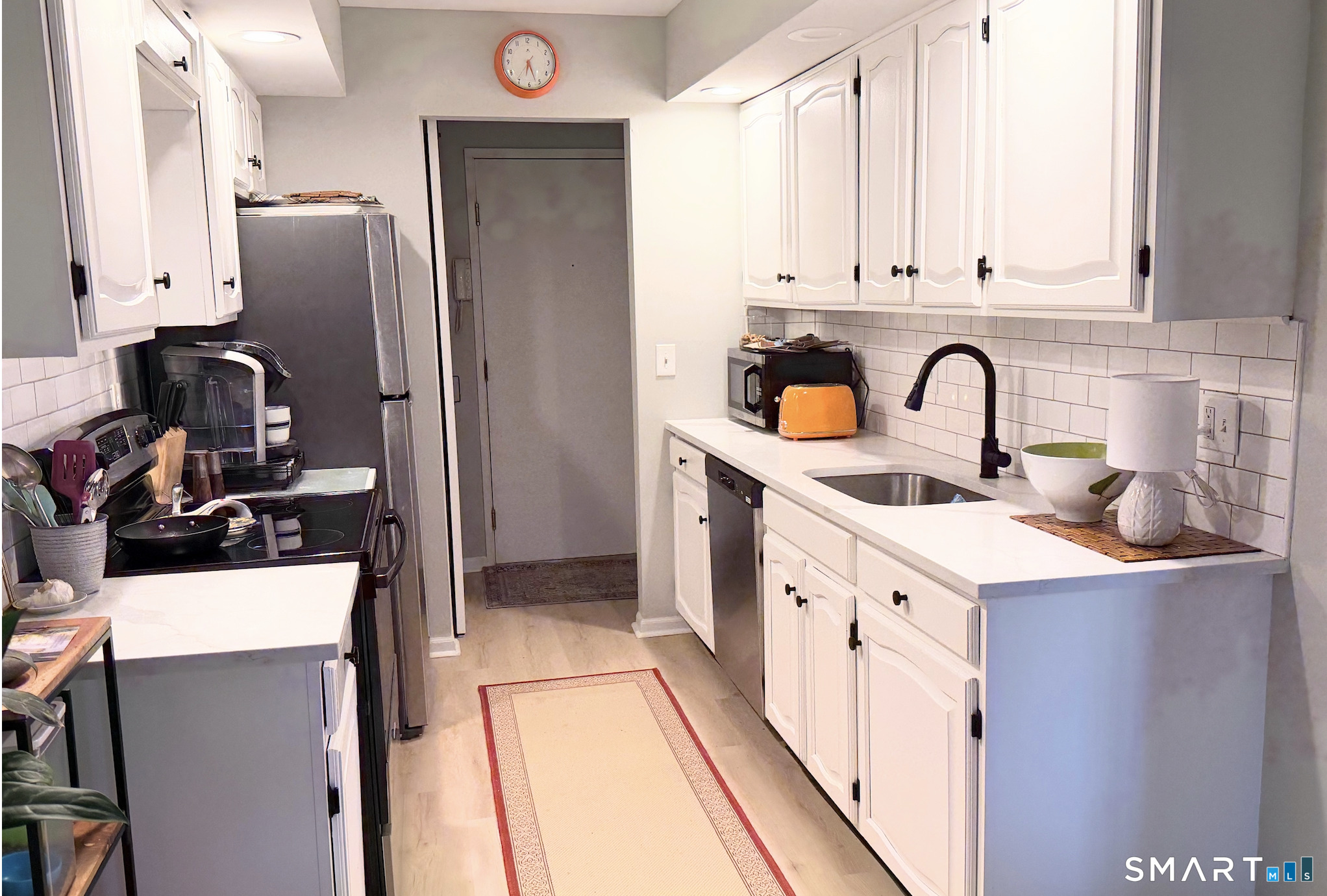 125 Warner Hill Road, Unit 20 Stratford, CT 06614 - Photo 11 of 17 a kitchen with stainless steel appliances a sink a refrigerator and cabinets
