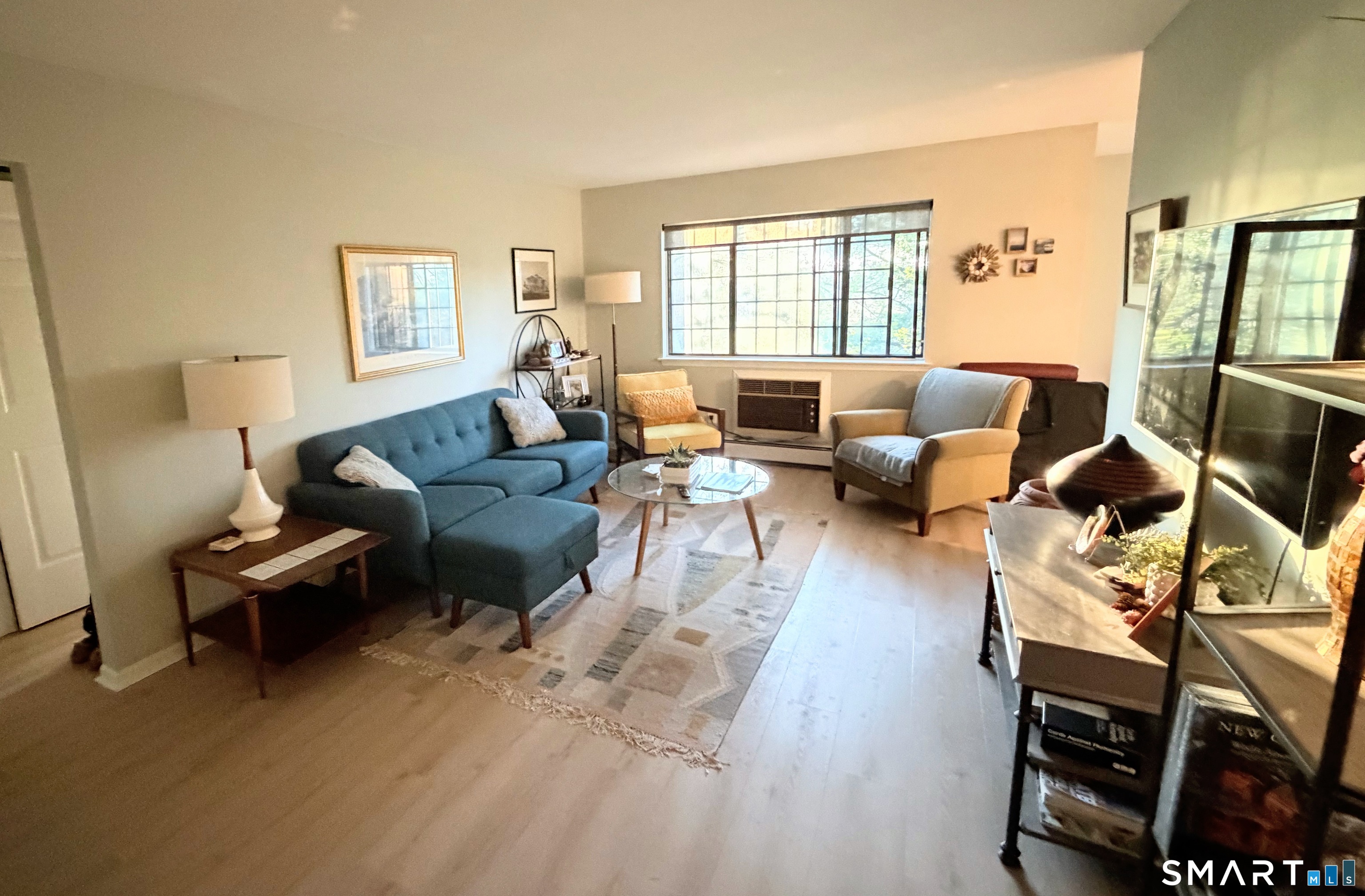 125 Warner Hill Road, Unit 20 Stratford, CT 06614 - Photo 3 of 17 a living room with furniture a rug and a window