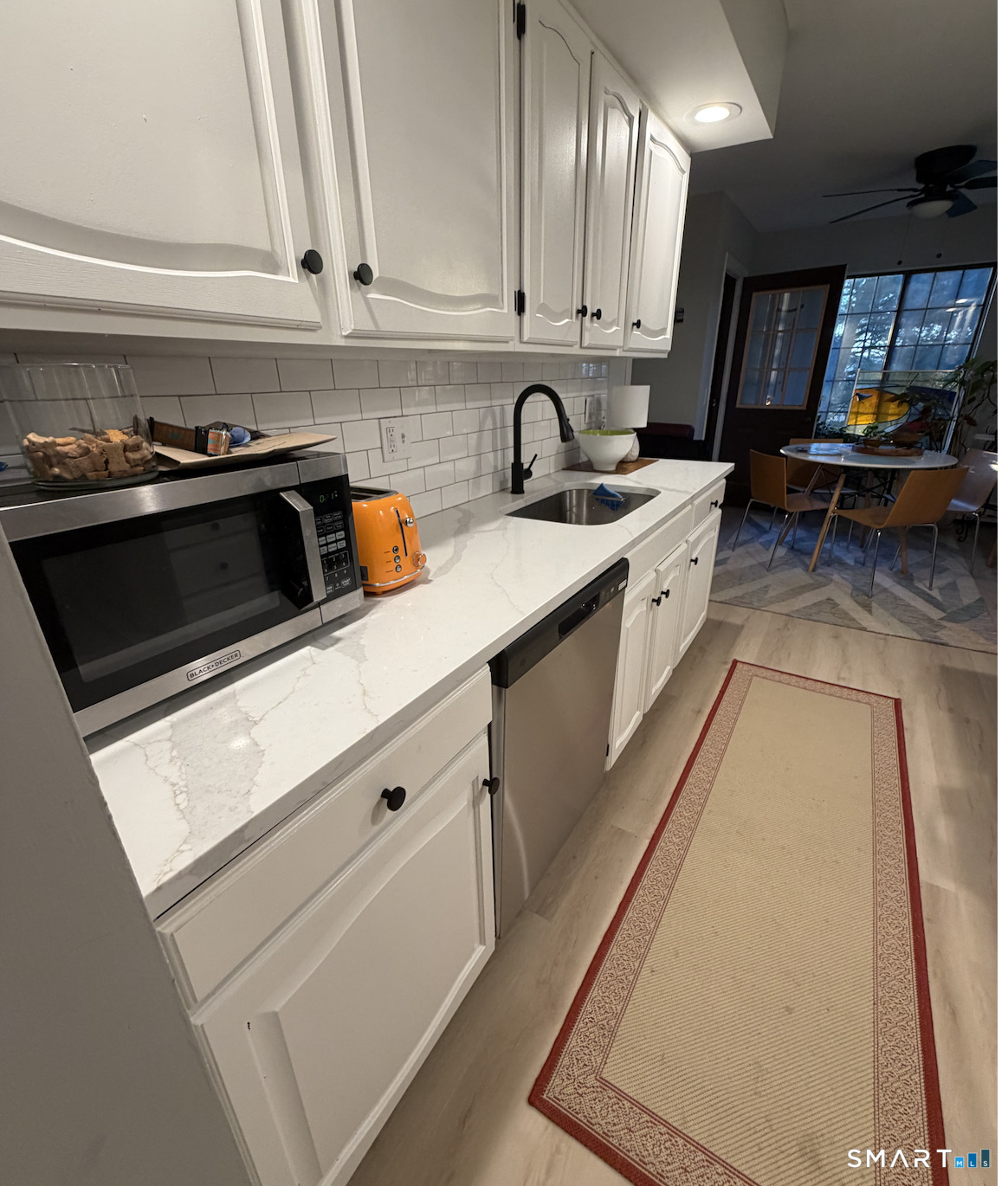 125 Warner Hill Road, Unit 20 Stratford, CT 06614 - Photo 9 of 17 a kitchen with stainless steel appliances a stove a sink and a microwave