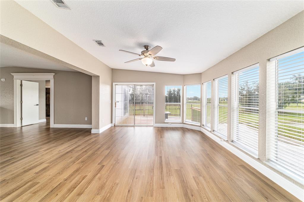 6155 Southeast Stetson Road Belleview, FL 34420 - Photo 12 of 68 a view of an empty room with wooden floor and a window