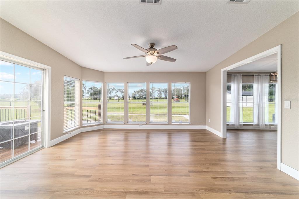6155 Southeast Stetson Road Belleview, FL 34420 - Photo 13 of 68 a view of an empty room with wooden floor and a window
